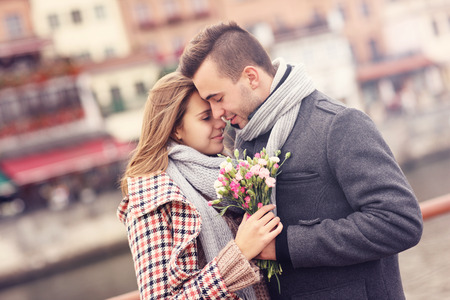 A picture of a romantic couple with flowers on an autumn walkの写真素材