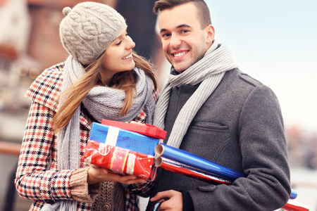 A picture of cheerful young people doing Christmas shoppingの写真素材