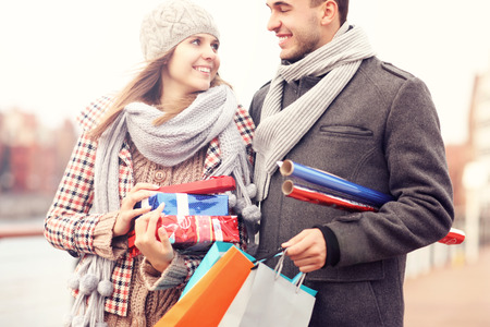 A picture of cheerful young people doing Christmas shoppingの写真素材