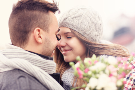 A picture of a romantic couple with flowers on an autumn walkの写真素材