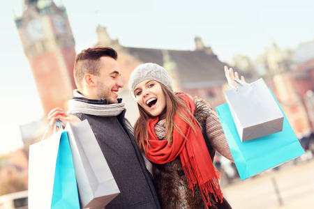 A picture of cheerful young people with shopping bagsの写真素材