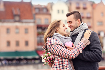 A picture of a couple on Valentine's Day in the city with flowers and heartの写真素材