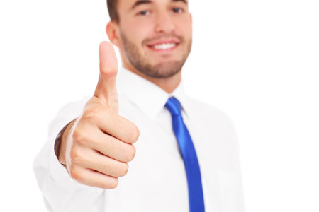A picture of a young confident businessman showing ok sign over white backgroundの写真素材
