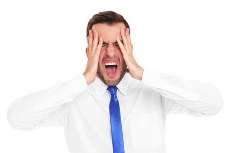 A picture of a stressed businessman screaming over white backgroundの写真素材