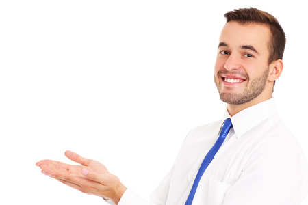 A picture of a happy businessman presenting something over white backgroundの写真素材