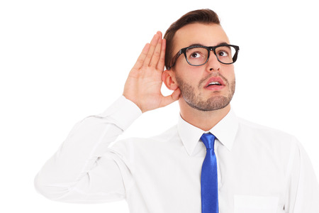 A picture of a happy businessman listening to something over white backgroundの写真素材