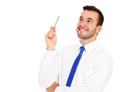 A picture of a successful businessman posing with a pen over white backgroundの写真素材