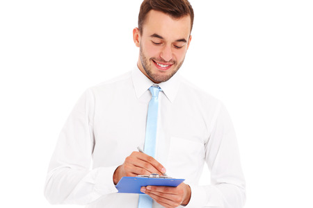 A picture of a happy businessman with documents over white backgroundの写真素材