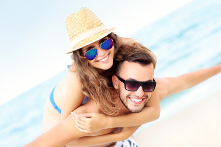 A picture of a happy couple having fun at the beachの写真素材
