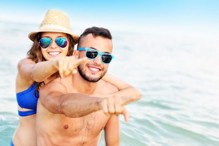 A picture of a happy couple having fun at the beachの写真素材