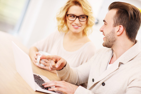 A picture of a happy couple using laptop at homeの写真素材
