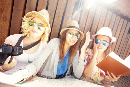 A picture of group of tourists using map in the cityの写真素材