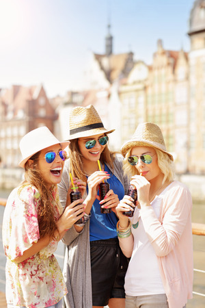 Group of friends drinking cocktails in the cityの写真素材