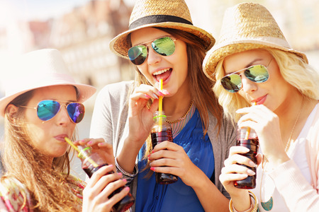 Group of friends drinking cocktails in the cityの写真素材
