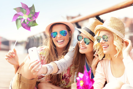 A picture of group of friends taking selfie in the cityの写真素材