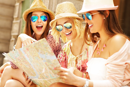 A picture of group of tourists using map in the cityの写真素材
