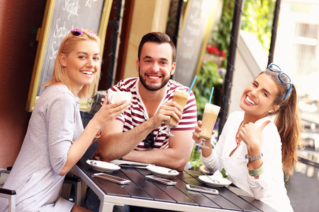 A picture of a group of friends resting in an outdoor cafeの写真素材