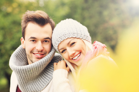 A picture of a young romantic couple in the park in autumnの写真素材