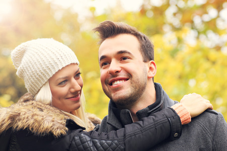 A picture of a young romantic couple in the park in autumnの写真素材