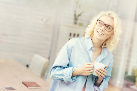 A picture of a young woman relaxing at home in the morningの写真素材