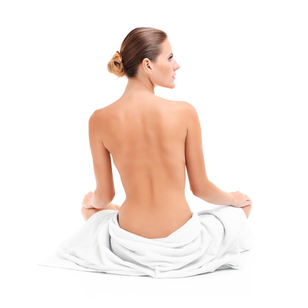 A picture of a sensual woman in a white towel over white backgroundの写真素材