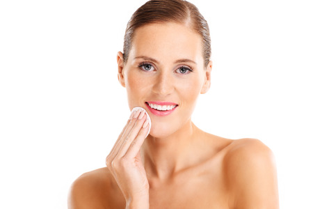A portrait of sensual woman removing makeup over white backgroundの写真素材