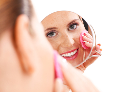 A portrait of sensual woman removing makeup over white backgroundの写真素材