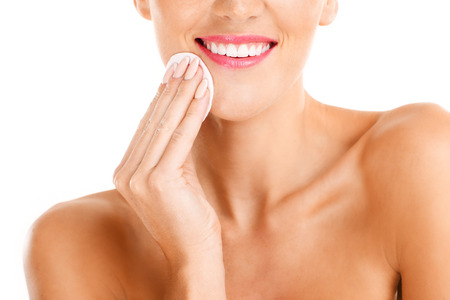 A portrait of sensual woman removing makeup over white backgroundの写真素材