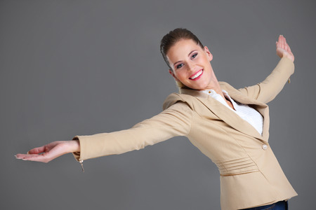 Picture of cheerful businesswoman over grey backgroundの写真素材