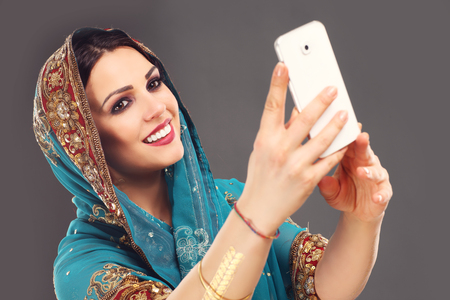 Portrait of oriental woman taking selfieの写真素材