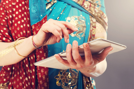 Midsection of oriental woman using tabletの写真素材