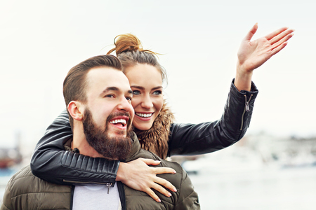 Picture of young couple pointing at something outsideの写真素材