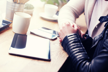 Midsection of couple holding hands in cafeの写真素材