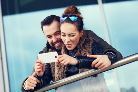 Picture of young couple hanging out in city and taking selfieの写真素材