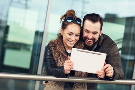 Picture of young couple using tablet outdoorsの写真素材