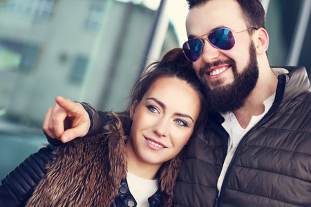 Picture of young couple hanging out and pointingの写真素材