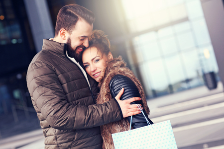 Picture of happy couple hugging while shoppingの写真素材
