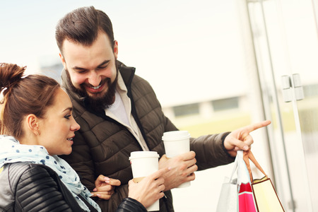 Picture of happy couple shopping and pointingの写真素材