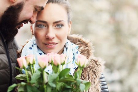 Picture of romantic couple on date with flowersの写真素材