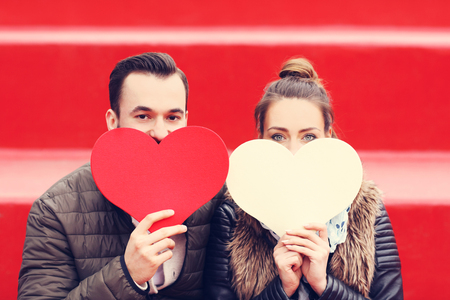 Picture of romantic couple having fun with heartsの写真素材