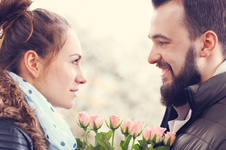 Picture of romantic couple on date with flowersの写真素材