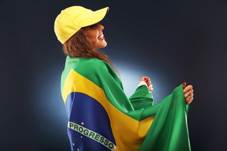 A picture of happy Brazilian fan cheering with flagの写真素材