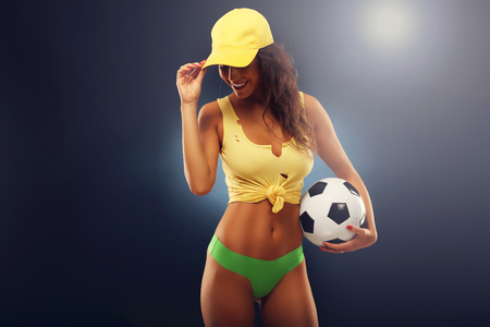 A picture of happy fan cheering with footballの写真素材