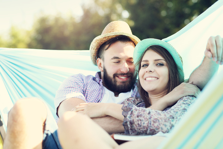 Picture of romantic couple relaxing in hammockの写真素材