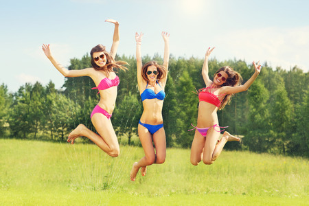 Picture presenting a group of women in bikin having fun outdoorsの写真素材
