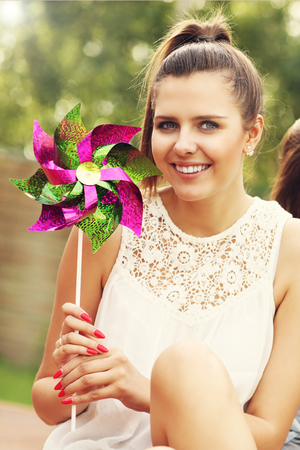 Picture presenting happy woman sitting outdoorsの写真素材