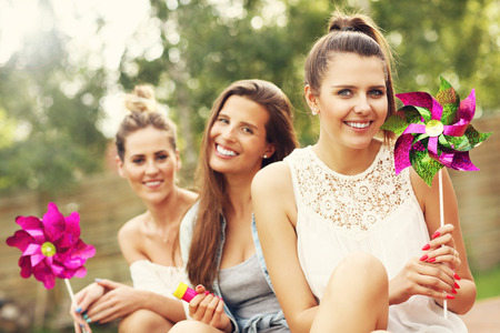 Picture presenting happy group of friends sitting outdoorsの写真素材