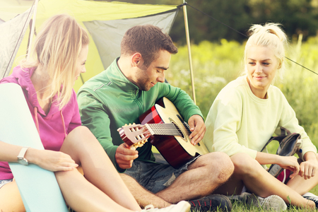 Group of friends camping in forestの写真素材