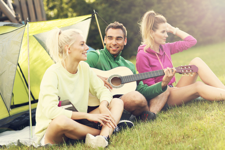 Group of friends camping in forestの写真素材