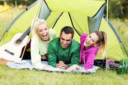 Picture showing group of friends camping in forestの写真素材